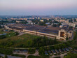 Drone view of production building in small city at sunset