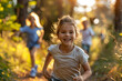 © Denis Mamin - Delight and laughter fill the forest as a young girl leads her friends in a spirited game of tag at golden hour
