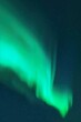 Bright green aurora borealis. Night starry sky and Northern lights