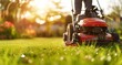 © inthasone - Lawn mower on green grass in a modern garden. Machine for cutting lawns.