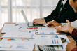 © Wicitr - Corporate business people working in busy marketing office space, planning strategy in books and reading email on laptop at work, workers at startup advertising company