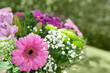 Colorful mixed flowers bouquet isolated on blur green background.