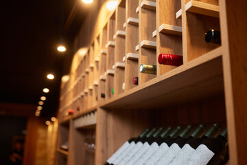 Building facade with hardwood shelving holding row of wine bottles