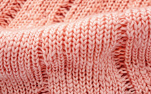 Close Up Of A Soft Pink Knitted Woolen Fabric Texture