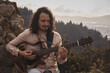 © Dainer - man playing guitar in the mountain