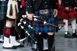 Traditional scottish bagpipers in kilts