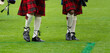 Traditional scottish kilt and bagpipe players at outdoor event
