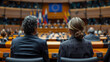© AY AGENCY - European Union politics concept image with back view of formal unrecognizable politicians at EU parliament in front of the European Union flag