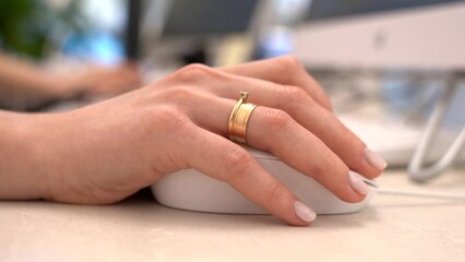 Close up of businesswoman hand using mouse working on computer Technology and business concept.