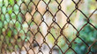 Old rusty chain link fence in the garden. Selective focus.
