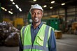 © aicandy - A Resilient Environmental Engineer Smiling Confidently While Standing Before the Complex Machinery of a Waste Management Plant