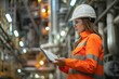 Petroleum oil refinery engineer woman worker in oil and gas industrial with personal safety equipment PPE to inspection follow checklist by tablet hardhat helmet adult.