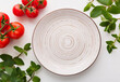 Empty ceramic plates on white wood table with kitchen Peppermint and red tomato