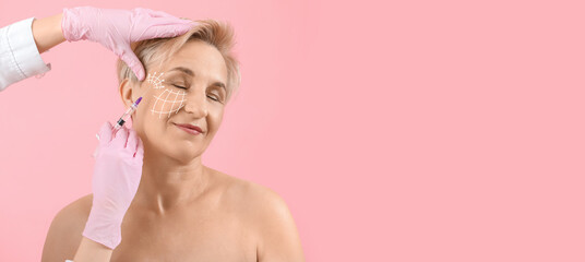 Sticker - Young woman receiving filler injection in face against beige background