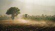 A refreshing rain shower washing over a dusty rural landscape, bringing relief to parched fields and rejuvenating the earth in the heart of the rainy season.