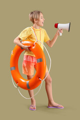 Wall Mural - Happy little boy lifeguard with ring buoy and megaphone on green background