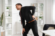 © Pixel-Shot - Businessman suffering from back pain in office