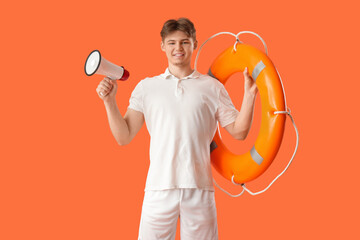 Wall Mural - Male lifeguard with ring buoy and loudspeaker on orange background