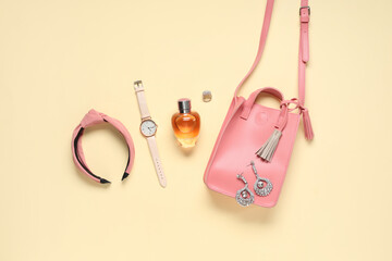 Wall Mural - Hair hoop, pink bag and bottle of perfume on beige background