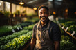 © sofiko14 - A young, happy man, a gardener, is growing lettuce in a greenhouse.