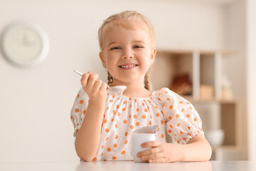 Sticker - Happy little girl with spoon and yogurt at home