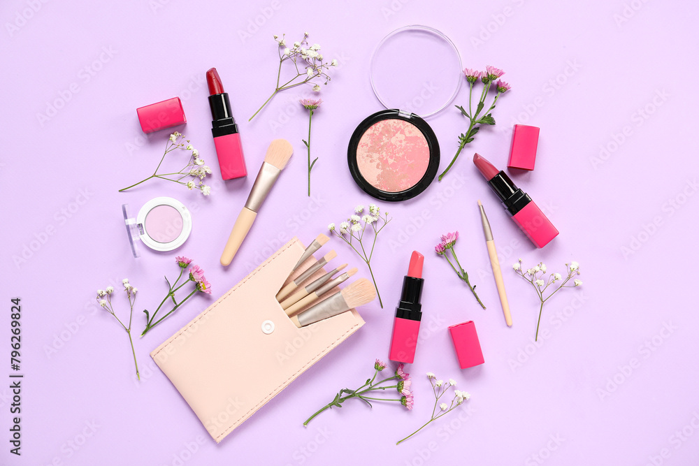 Beautiful composition with flowers, brushes and decorative cosmetics on lilac background