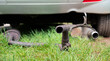 Broken exhaust and muffler of a car, rusted silencer fallen down on the road, breakdown of vehicle 
