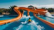 Water slide background banner featuring an orange aqua park slide that emerges into stunning blue waters