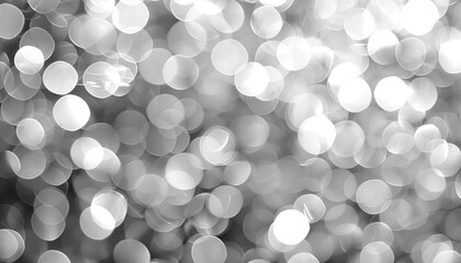 Abstract grey light bokeh background with blurred defocused effect for elegant design projects