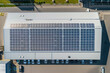Solar panels installed on the roof of a warehouse, generating clean electricity and reducing carbon footprint.