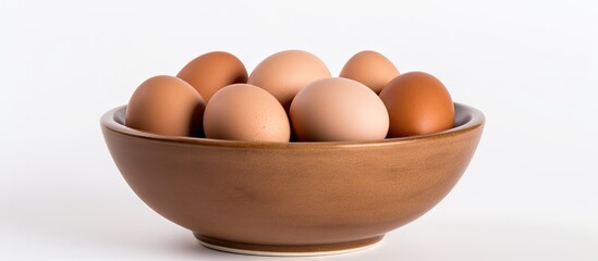 Canvas Print - Brown bowl filled with eggs on plain white surface