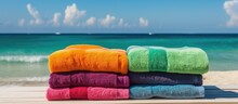 Colorful Beach Towels And Flip Flops By Ocean