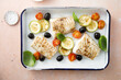 Roasted cod with olives, tomato and zucchini