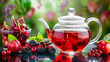 Freshly brewed fruit and berry tea in a glass tea pot on gradient red background. Vitamins health concept