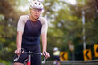 outdoor portrait of young male asian cyclist looking at camera