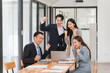 © Kritdanai - Young motivated Asian business team discussing oh business strategy in the modern meeting room.