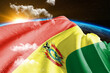 Bolivia national flag cloth fabric waving on beautiful night global Background.
