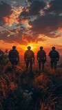 Fototapeta Tulipany - Four soldiers standing in front of a sunset