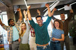 Happy young successful business team celebrating a triumph with arms up in startup office.
