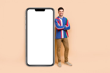 Canvas Print - Full length photo of confident businessman in casual clothes folded hands guy advertise mobile app isolated on beige color background