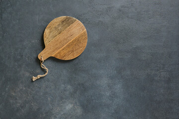 Wall Mural - Wooden cutting board on the decorative table, view from above, napkin, empty, textured background.