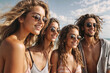 © Pham Ty - Smiling friends in sunglasses with surfs on beach. Young female people spending summer days on the beach with friends
