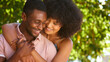 © Monkey Business - Close Up Portrait Of Loving Multi-Racial Couple Or Friends Hugging Outdoors  In Countryside Together
