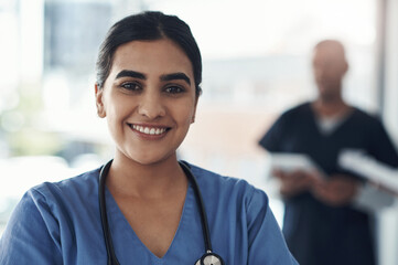 Canvas Print - Portrait, nurse and happy woman in hospital for healthcare career, wellness and service in Brazil. Face, smile and young medical professional doctor, surgeon and expert employee working in clinic