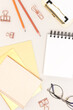 Yellow colored school supplies on a gray background. Clean notepad.