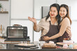 Happy asian family senior mother and daughter cooking in kitchen