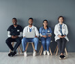 © peopleimages.com - Chairs, team and portrait of doctors by wall for interview or public health conference and training meeting. People, medical staff and line for patient rounds or daily briefing, review and proud.