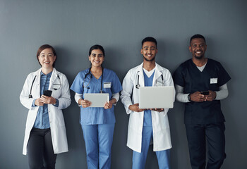 Wall Mural - Doctor, teamwork and technology on wall background for research, planning and multimedia workflow. Healthcare worker, group and nurse in portrait with laptop, tablet and phone for contact or about us