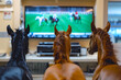 Horses animal watching horse racing and sports betting statistics in the living room sitting on the sofa. Betting house. Generative AI.