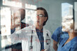 © peopleimages.com - Medical team, people and writing on glass for solution, teaching and problem solving with students in residency. Healthcare doctor, nurse and expert for orthopedic training, steps or ideas on mindmap
